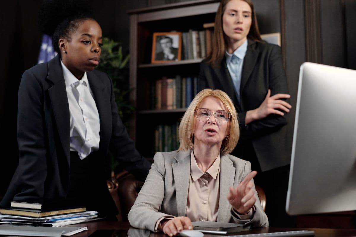 Attorneys reviewing trucking accident lawsuit defense documents in a law office
