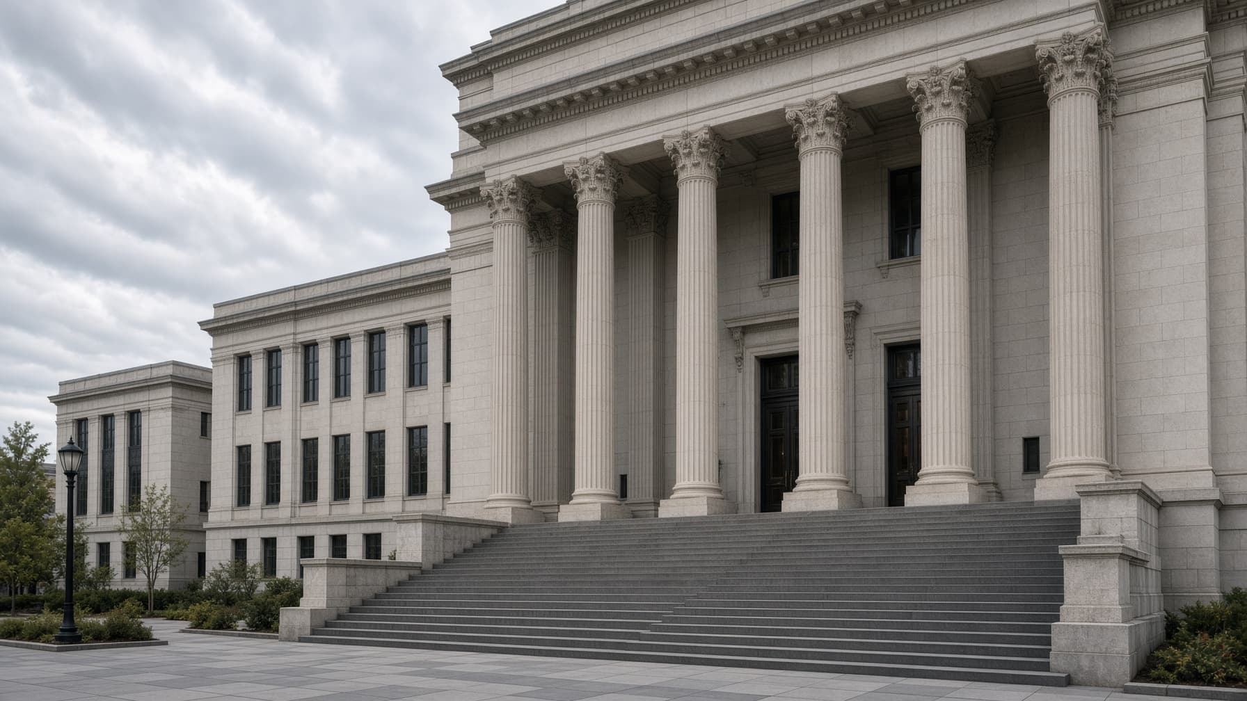 A federal courthouse exterior with steps and columns on an overcast day